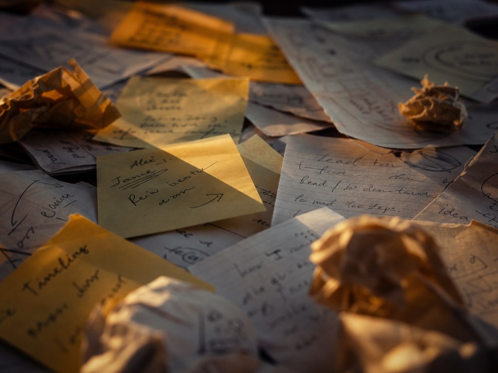 Handwritten notes and scattered paper from business conversations